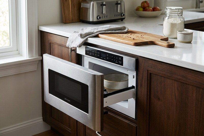 Microwave drawer pulled open under the kitchen countertop